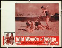 3b694 WILD WOMEN OF WONGO lobby card '58 great image of cave babe sticking spear into catfight!