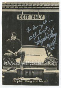 6s378 STEPHEN KING signed 6x8.75 REPRO still '86 cool image of the horror writer sitting on car!