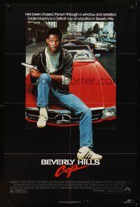 6c107 BEVERLY HILLS COP 1sh '84 great image of cop Eddie Murphy sitting on Mercedes!