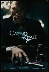 7w104 CASINO ROYALE teaser DS 1sh '06 Craig as James Bond sitting at poker table w/gun!