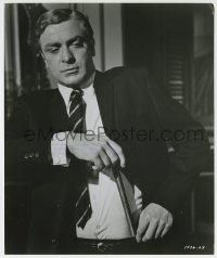 1h338 GAMBIT 8.25x9.75 still 1967 c/u of Michael Caine pulling a large metal bar from his pants!