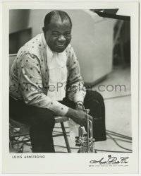 1h575 LOUIS ARMSTRONG 8x10 music publicity still 1940s seated & smiling close up with his trumpet!