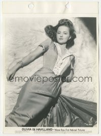 1h696 OLIVIA DE HAVILLAND 8x11 key book still 1940s great overhead portrait laying on fur rug!