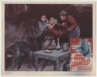 4p393 HAUNTED GOLD LC R1956 c/u of young John Wayne fighting two bad guys in their hideout!