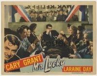 9y703 MR. LUCKY LC 1943 gambler Cary Grant looks bored as women knit for war relief fund raiser!