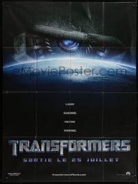 1c954 TRANSFORMERS teaser French 1p 2007 huge robot eye looming over Earth, directed by Michael Bay!