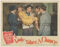 4w0635 LADY TAKES A CHANCE LC 1943 John Wayne carrying Jean Arthur in his arms, talking to 3 guys!