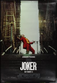 1g0083 JOKER DS bus stop 2019 Joaquin Phoenix as the DC Comics villain at the top of the steps!