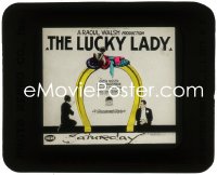 2t1622 LUCKY LADY glass slide 1926 Lionel Barrymore by Greta Nissen sitting on giant horseshoe!