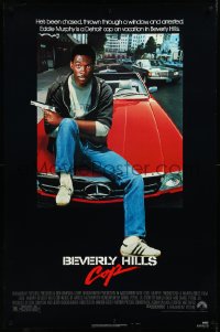 3m0767 BEVERLY HILLS COP 1sh 1984 great image of detective Eddie Murphy sitting on red Mercedes!