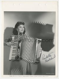 3x0556 PAULETTE GODDARD signed 8x11 key book still 1940 playing accordian, which is her new hobby!