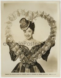 4f1484 OLGA SAN JUAN 8x10.25 still 1945 wearing a wild dress & tiny hat posing in a big lace heart!