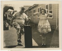 4f1525 ROSCOE FATTY ARBUCKLE/VIORA DANIEL 8.25x10 still 1920 lighting a giant prop firecracker!