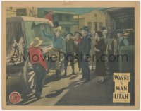 5j1428 MAN FROM UTAH LC R1930s John Wayne showing contents of stagecoach to townspeople, rare!