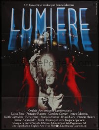 5y0219 LUMIERE French 1p 1976 directed by Jeanne Moreau, who's looking at a film strip!