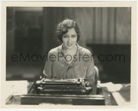 7b1402 TRESPASSER 8x10 still 1929 Gloria Swanson seated at manual typewriter with half smile!