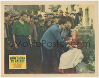 7p0865 HOW GREEN WAS MY VALLEY LC 1941 crowd watches Walter Pidgeon help unconscious Anna Lee, Ford!